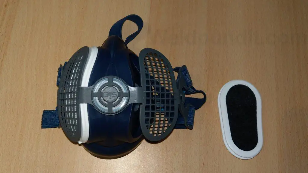 Half-face reusable elastomeric respirator with combination filters for welding