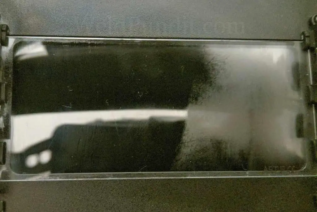 A photo of a welding inside cover lens that is half fogged after applying liquid soap