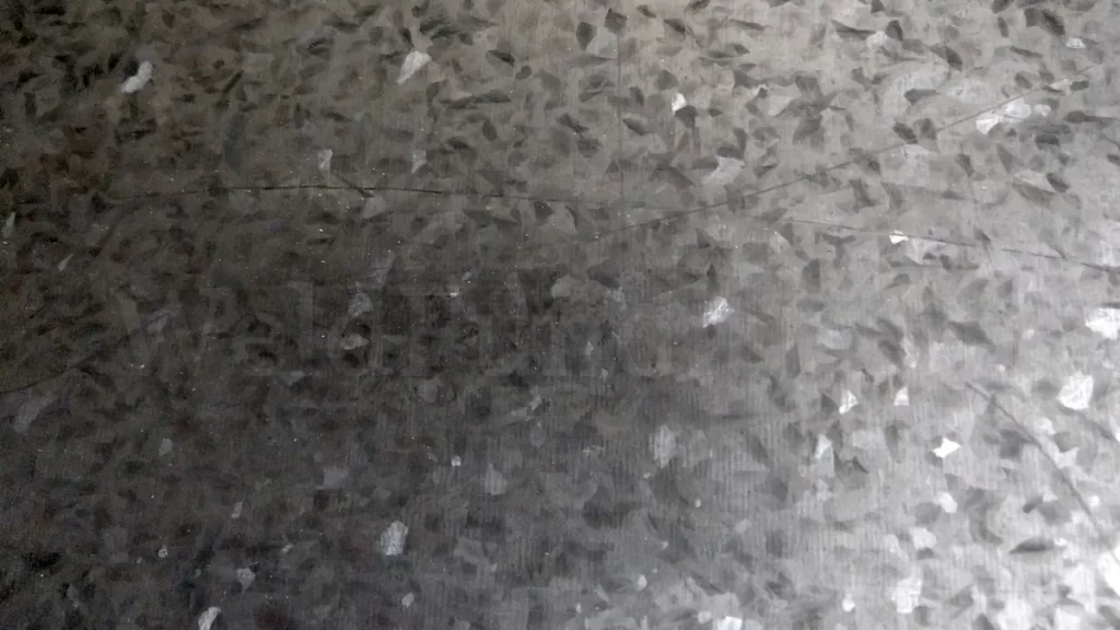 A photo of hot-dipped galvanized steel with visible spangle